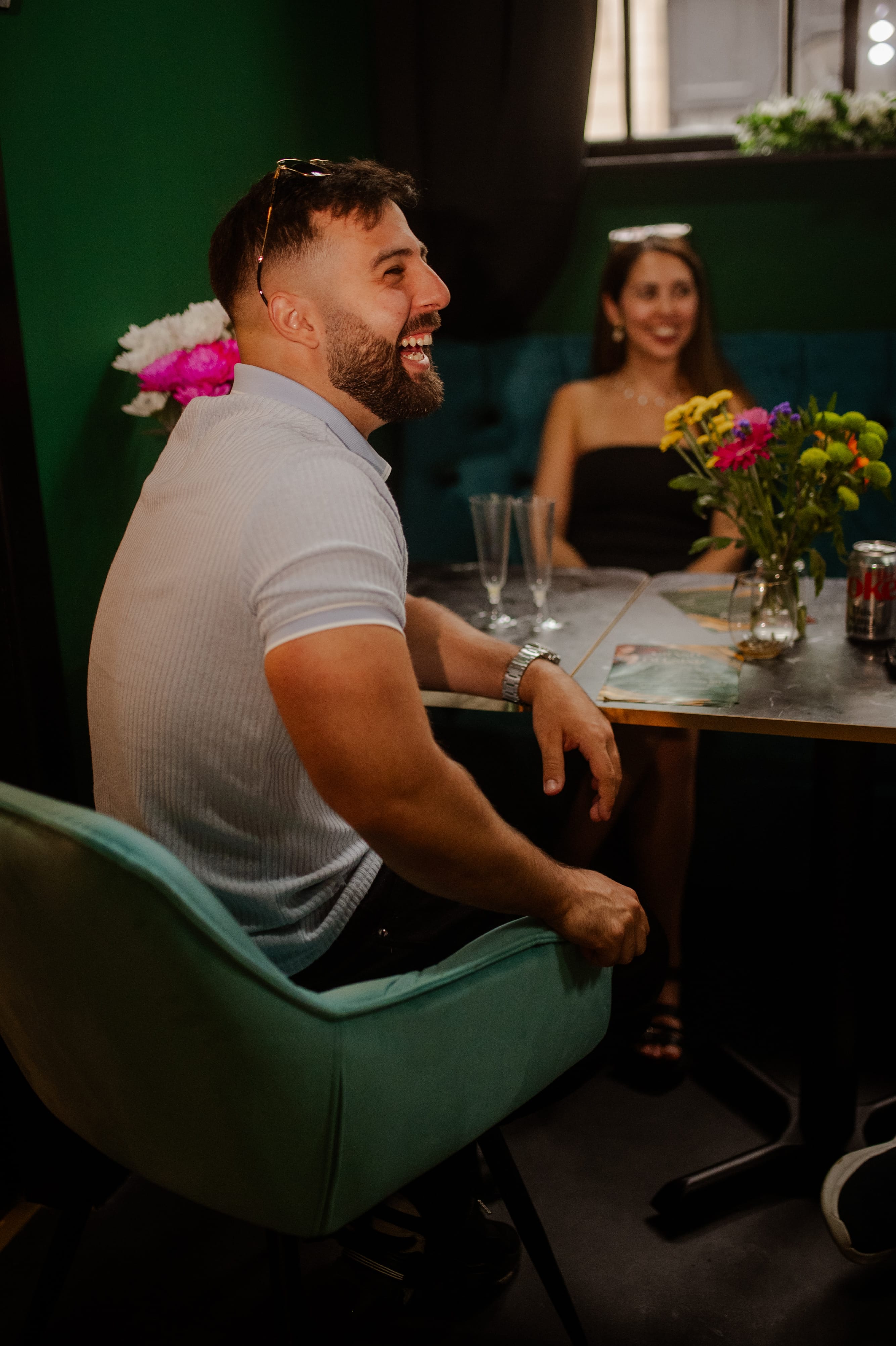 Guests laughing over brunch at a marble table